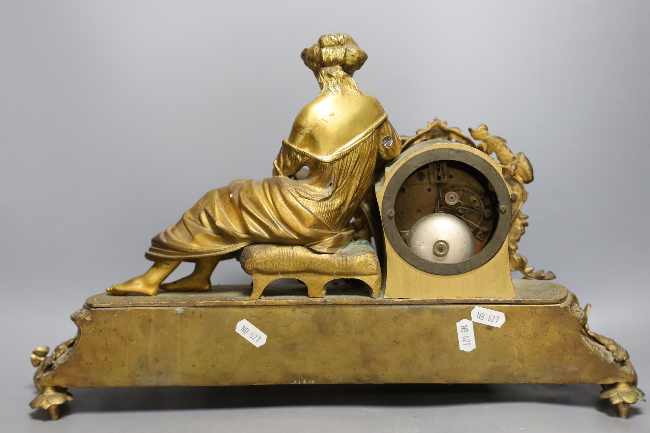 A French gilt metal mantel clock with blue enamel floral decoration and mounted lady reading - 47cm long